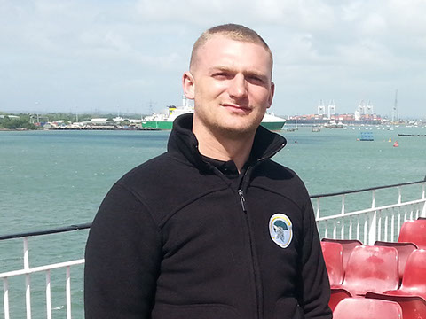 Gladiator removal man standing on a ferry.